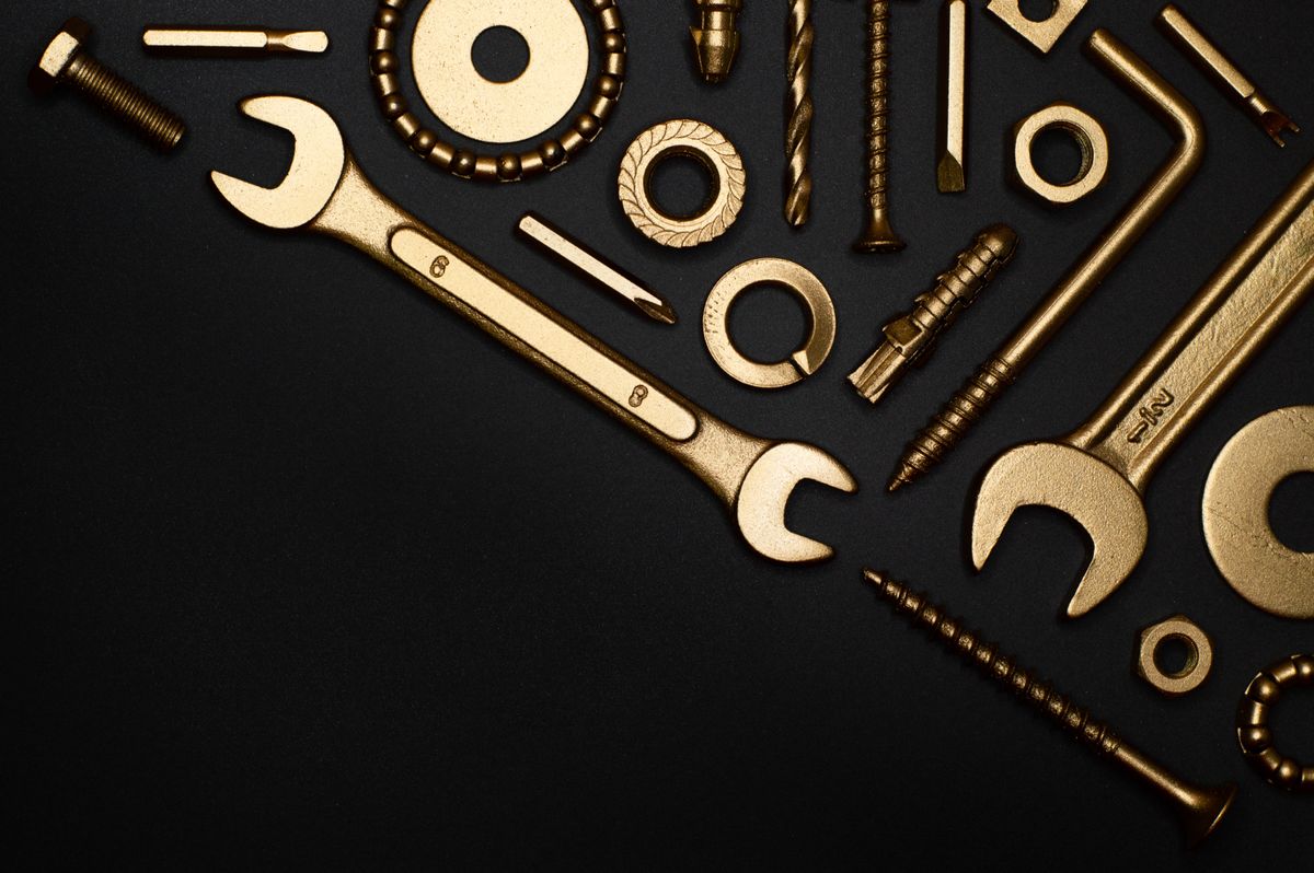 Plumbing tools laid out flat, representing the range of jobs behind a plumber's quote